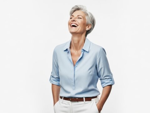 Smiling elderly woman laughing with hands on hips
