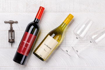 Fototapeta premium Red and white wine bottles mockup on wood