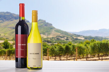 Fototapeta premium Wine bottles mockup in sunlit vineyard