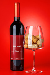 Fototapeta premium Red wine bottle mockup on red background