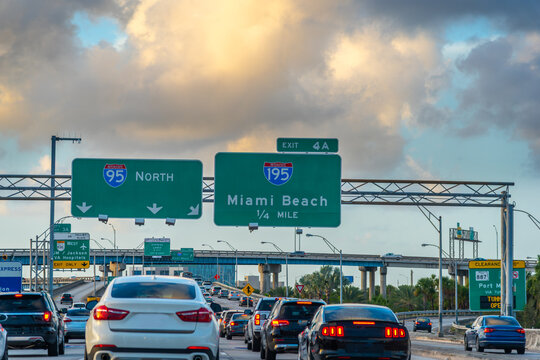Traffic flow on Highway 95 in Miami at sunset with city skyline