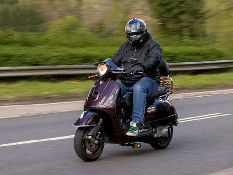 Milton Keynes,Bucks,UK - Apr 13th 2026:  2007 Piaggio Vespa gt 125 scooter driving on a British road
