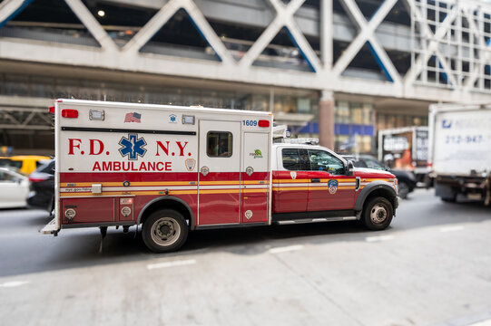 New york, usa august 15,2024. Fdny ambulance racing through manhattan street with siren and flashing lights, providing urgent ems and first response care