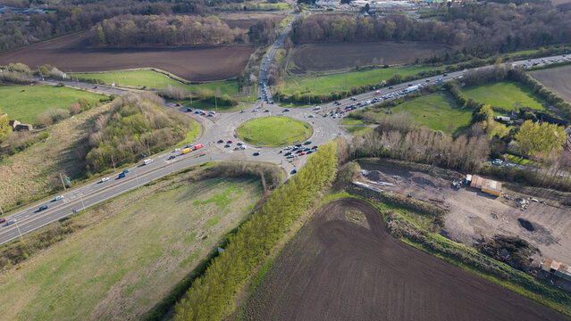 Aerial view of the iconic Sheriffhall Roundabout on the Edinburgh City Bypass (A720). A massive multi-lane road junction in Midlothian, Scotland, captured from a high altitude drone perspective