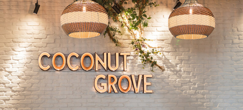 Coconut Grove illuminated wall sign with decorative pendant lights