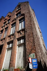 Verkehrszeichen und schöne alte Backsteinfassade mit Treppengiebel bei blauem Himmel und Sonnenschein in den Gassen der Altstadt von Brügge in Westflandern in Belgien © Martin Debus