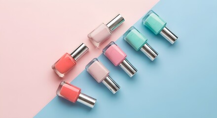 Obraz premium Variety of Nail Polish Bottles in Pastel Colors on Divided Pink and Blue Background