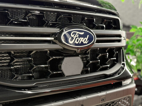Black Ford Ranger Supercrew 4X4 XLT SUV car logo on radiator grille. USA Ford logo, luxury car dealer and manufacturer, global automobile manufacture. American SUV car. 
