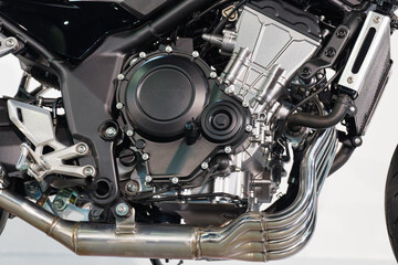 Fototapeta premium Close-up of a motorcycle engine and exhaust headers with mechanical details