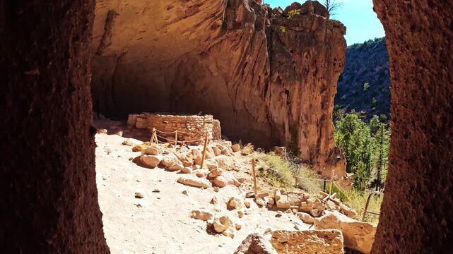Scenic view of ancient settlements carved into rock cliffs at Bandelier National Monument in New Mexico