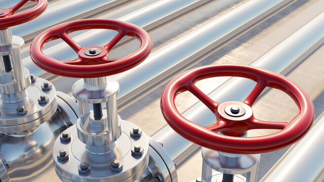Close-up of industrial pipeline system with red valve wheels controlling the flow of liquids or gases. The metallic pipes and shut-off valves represent infrastructure for oil, gas,