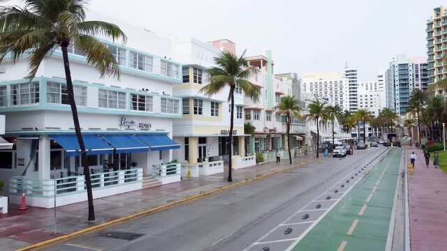 Aerial backward drone shot along Ocean Drive in Miami Beach Florida 4K