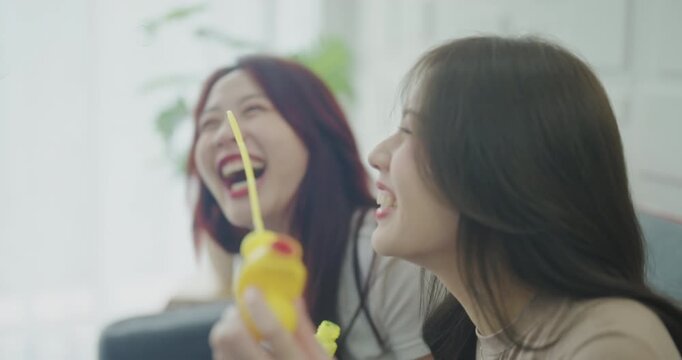 Holiday concept of 4k Resolution. Asian women blowing soap bubbles together inside home.