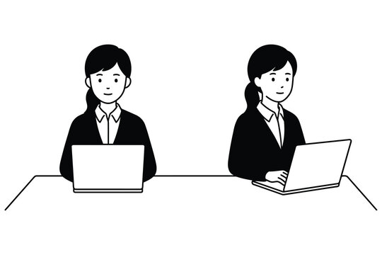 Two business women working on laptops at a desk with black and white business computer collaboration workplace