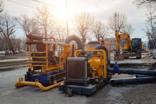 Vacuum pump cleaning sewer manholes. Pumping of sewage in flooded sewer