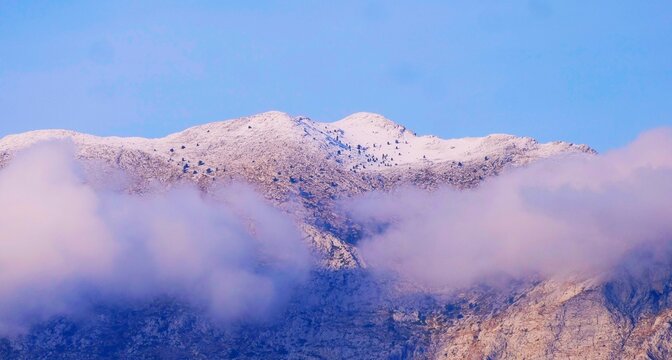 Mountain peak covered with snow and foggy dreamy clouds in nature big mountain landscapes