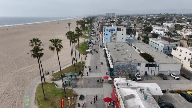 Venice Beach, California, USA - Aerial Top View of Boardwalk on the Marvin Braude Bike Trail With Tourists and Palm Trees