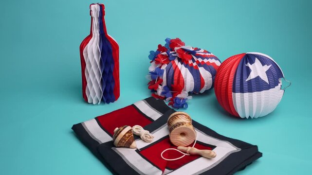 Chilean flag decorations with traditional games like the spinning top and the ball in a cup for fiestas patrias