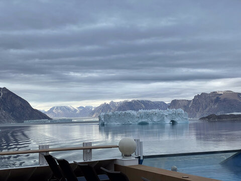 cruise ship deck with swimming pool overlocking arctic icebergs