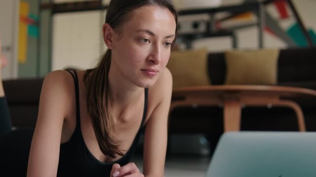 Woman Doing Fitness at Home with Laptop