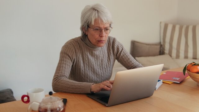 Older Woman Working on Laptop at Home