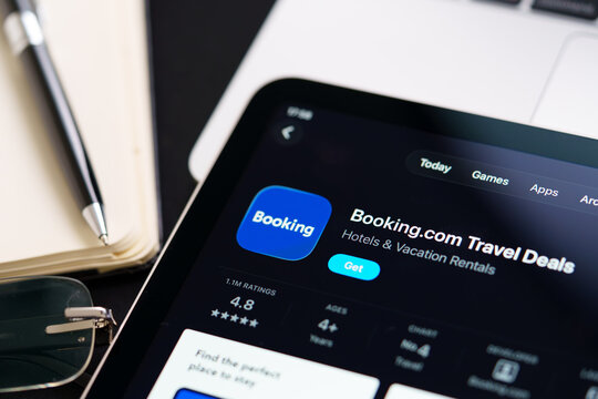 Booking.com iPad App Store screen showing Apple Liquid Glass redesign and iOS 26 style in workspace closeup. Stafford, United Kingdom, April 13, 2026.