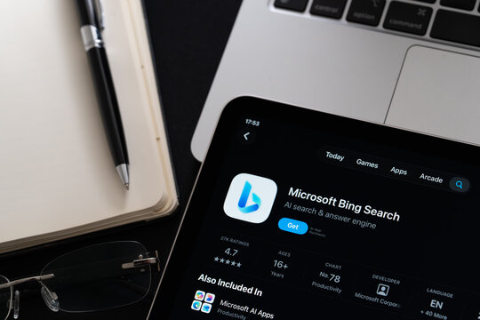 Microsoft Bing app on iPad with Apple Liquid Glass updated look and iOS 26 design on desk beside notebook and laptop. Stafford, United Kingdom, April 13, 2026.