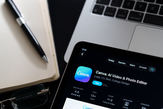 Canva listing on iPad highlights Apple Liquid Glass updated design and iOS 26 look in office desk scene. Stafford, United Kingdom, April 13, 2026.