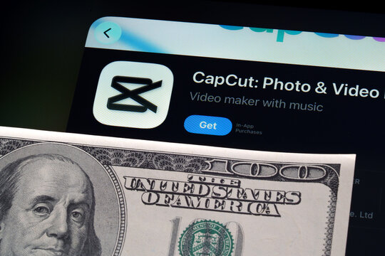 CapCut app on iPad showing Apple Liquid Glass redesign and iOS 26 App Store look beside US dollar banknote. Stafford, United Kingdom, April 13, 2026.