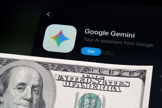Google Gemini logo and App Store page on iPad in Apple Liquid Glass iOS 26 design beside US dollar note. Stafford, United Kingdom, April 13, 2026.