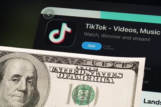 TikTok iPad App Store screen with Apple Liquid Glass updated look and iOS 26 styling next to 100 dollar bill. Stafford, United Kingdom, April 13, 2026.