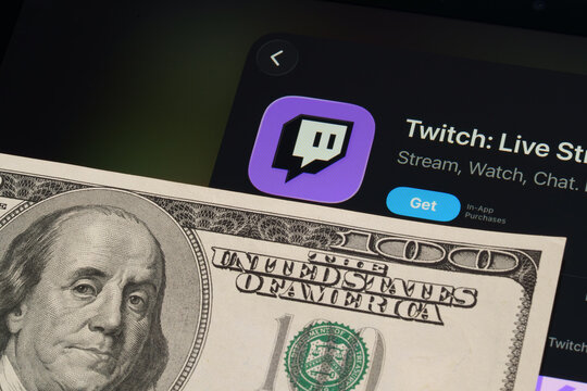 Twitch listing on iPad highlights Apple Liquid Glass interface and iOS 26 update with dollar bill foreground. Stafford, United Kingdom, April 13, 2026.