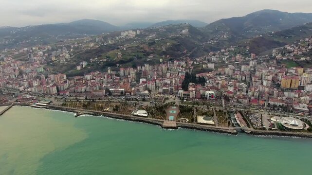 Aerial view shows brown runoff meeting clear blue sea along the coast of Trabzon. Contrasting currents form a visible boundary where turbid flow and marine water remain separate.