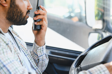 Indian truck driver communicating with walkie talkie
