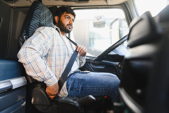Indian truck driver buckling seatbelt for safety
