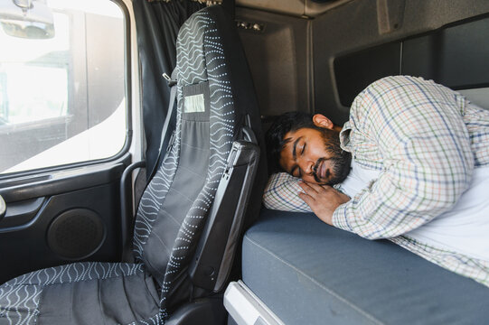 Truck driver sleeping resting inside cab during break