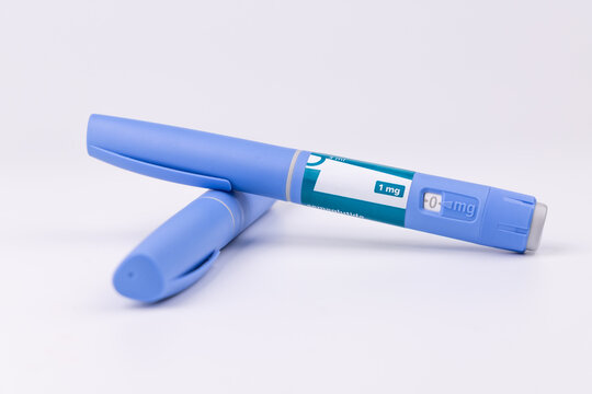 Blue medical pens for glp-1 semaglutide therapy on a white background for illustrating diabetes control and morbid obesity treatment.