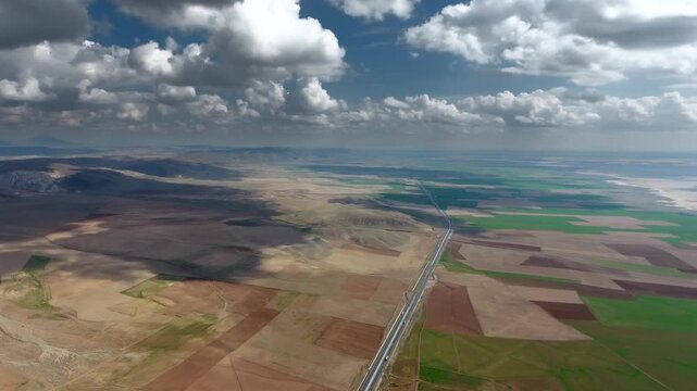 Aerial panoramic view of Tuz Golu salt lake across arid Central Anatolia plains at daylight. Vast saline basin reflects sky tones above dry treeless geography turkey beside saltlake.