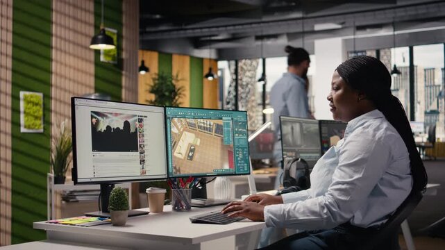 African american architectural developer working with remodeling software for apartment layout, interior design program on computer. 3D rendering on dual monitors in the office.