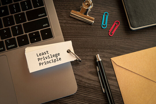 Secure technology and Least Privilege Principle on word card with laptop, clips, pen. Cyber security, protection and digital trust.