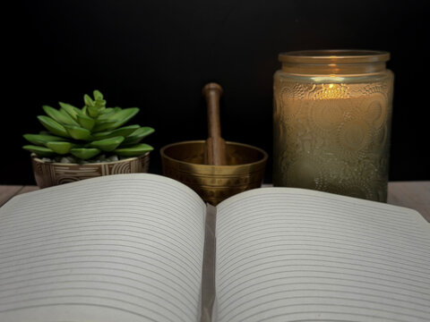 Open Book with Singing Bowl Candle and Succulent Plant for Meditation Spiritual Reflection Mindfulness Practice Wellness Concept Calm Healing Environment Holistic Self Care and Inner Peace Scene