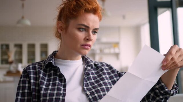 Disappointed shocked Caucasian woman reading bad news letter at home couch upset female opening envelope worried girl bank debt bankruptcy unemployment failure financial problem dismissal apartment