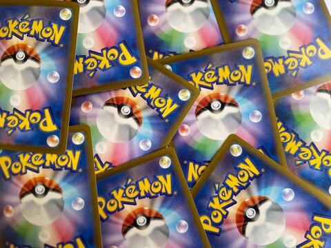 Bekasi, Indonesia - March 04, 2026: A collection of Pok&eacute;mon Trading Card Game (TCG) cards showing the iconic back design with Pok&eacute; Ball and logo scattered on a surface.

