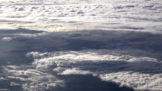 Convergence zone cloud deck shifts Earth energy budget, shading ocean surface from sunlight. ITCZ atmospheric overcast alters solar flux, lowering insolation across sea beneath layered cumulus.
