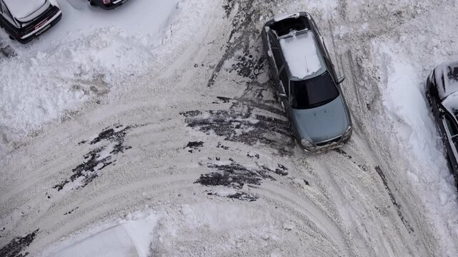 winter parking difficulties residential courtyard snow-covered cars top view neighborhood