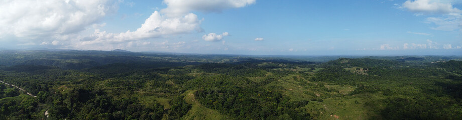Fototapeta premium Panoramic aerial view of forest in norcasia Caldas, Colombia, blue sky nature landscape