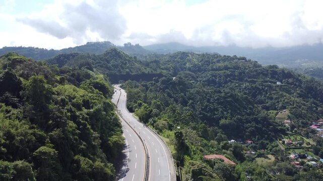 Road in middle of mountains cars and ciclist La vega Cundinamarca Colombia, cloudy sky