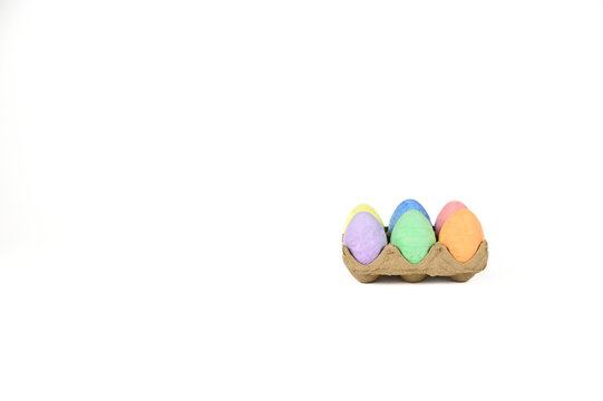 Easter basket stuffer of cardboard egg tray holding six brightly colored chalk Easter eggs 