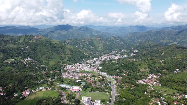 Aerial view from drone approaching la vega town in cundinamarca Colombia, Mountains arround blue sky