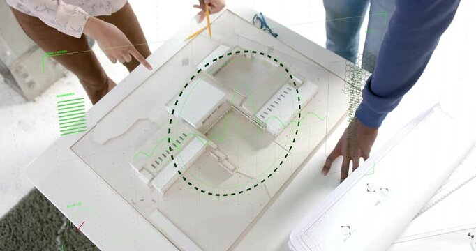 Diverse coworkers leaning over white scale model at studio, tracing center with yellow pencil
